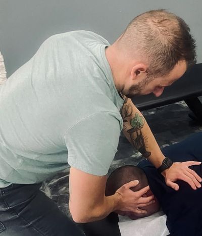 Chiropractor, Dr. David Estis, performing a chiropractic adjustment on a patient dealing with back and neck pain